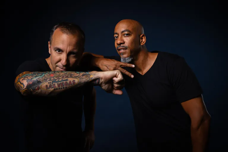 Dynamixx and Babae in a playful studio pose