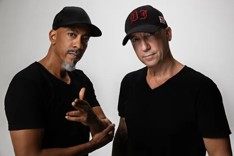 Babae and Dynamixx wearing black caps
